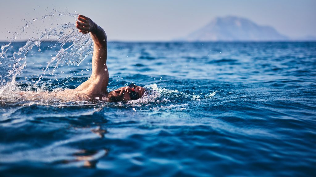 Summer activity: enjoying a sunny beach day with ocean swimming